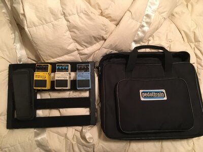 Various Pedals and a Bord with Carrying Case