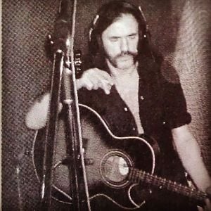 Lemmy with a Washburn Festival Series Guitar