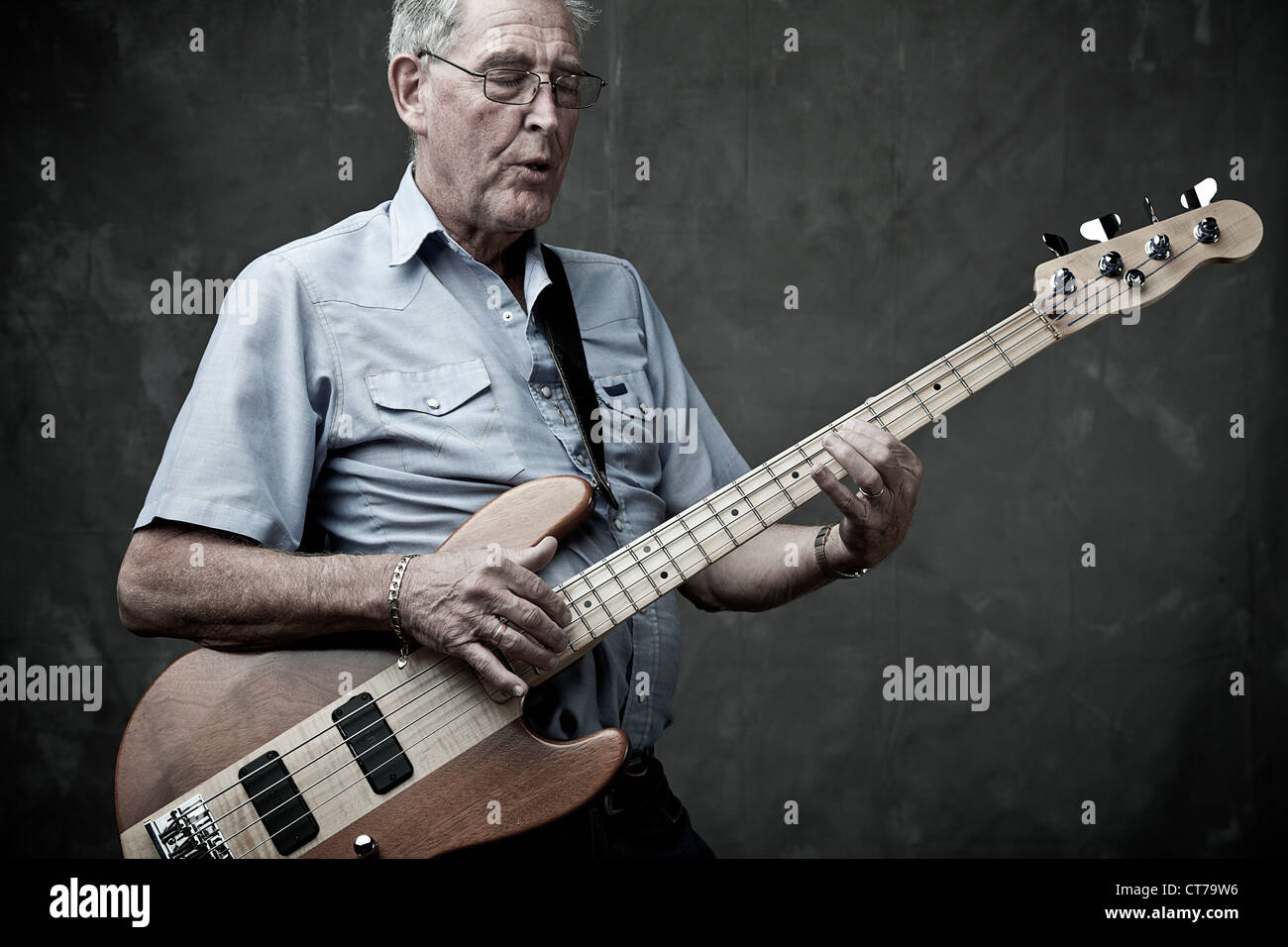 senior-man-playing-bass-guitar-CT79W6.jpg